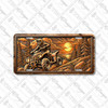 ATV rider license plate featuring a four-wheeler climbing rocky terrain at sunset with pine trees and bronze embossed-look design on aluminum.