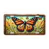 Monarch butterfly in a wildflower meadow illustrated on a 12x6 aluminum license plate, featuring colorful butterfly and floral nature artwork.
