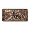 Wolf license plate featuring a detailed copper-toned mountain scene with embossed-look artwork on aluminum.