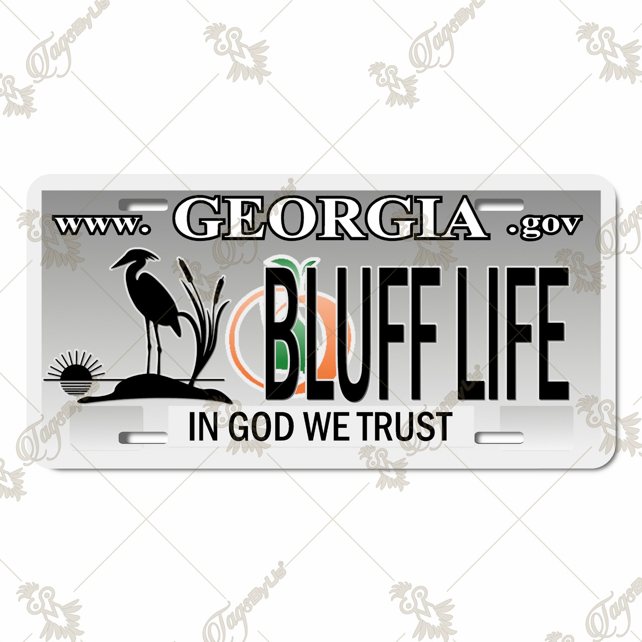 Georgia Bluff Life license plate featuring heron silhouette, cattails, peach accent, bold “BLUFF LIFE” text, and “In God We Trust” phrase, rustic embossed-look artwork on aluminum.