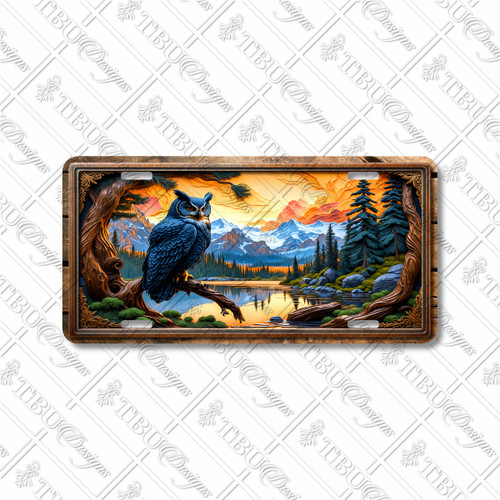 Rustic blue owl license plate with mountain sunset background, pine forest, and carved-wood style frame on aluminum.