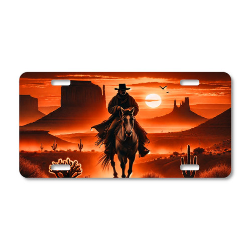 Western cowboy sunset license plate featuring shadowed cowboy on horseback riding through desert canyon with mesas and cacti in fiery orange tones.