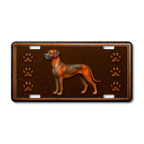 Great Dane dog license plate featuring a tall copper-toned Great Dane with muscular build, ornate embossed-look swirls, and paw prints on a rustic aluminum background.