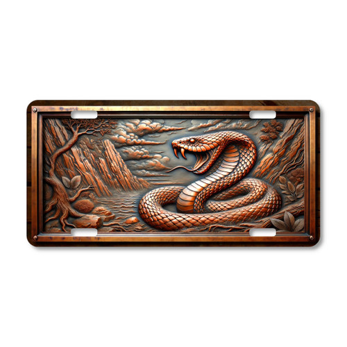 Viper snake license plate featuring coiled serpent with fangs bared, canyon backdrop, and stormy desert skies in rustic embossed-look artwork on aluminum.
