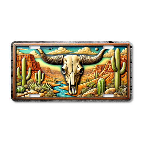 Western cow skull license plate featuring a longhorn skull set in a Southwestern desert canyon with cacti and red rock cliffs.