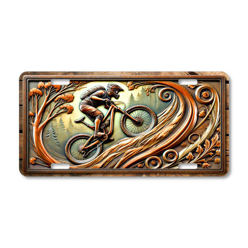 Mountain biker aluminum license plate featuring a trail rider cycling through a forest with decorative outdoor scrollwork in detailed action artwork.