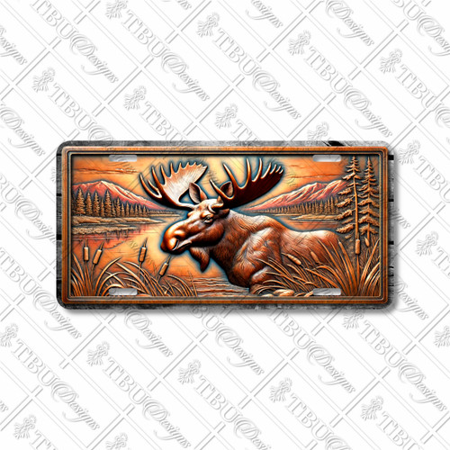 Moose license plate featuring a rustic lake and mountain scene in bronze and copper tones with embossed-look artwork on aluminum.