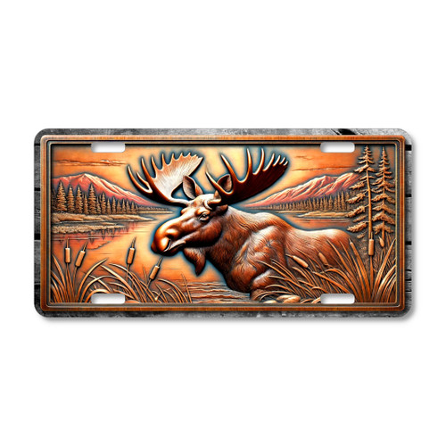 Moose license plate featuring a rustic lake and mountain scene in bronze and copper tones with embossed-look artwork on aluminum.