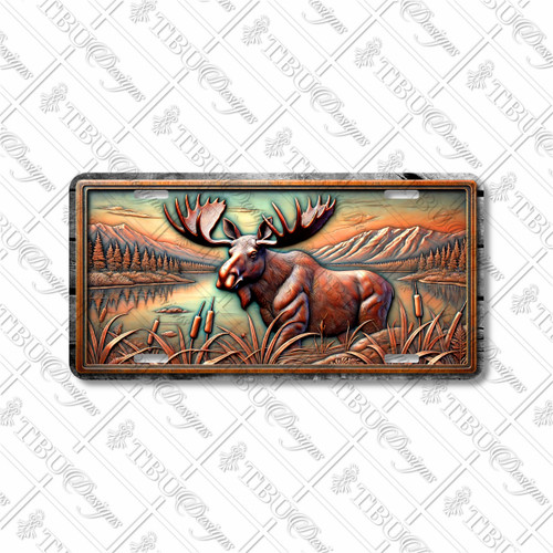 Moose license plate featuring a tranquil lakeside mountain scene in bronze and copper tones with embossed-look artwork on aluminum.