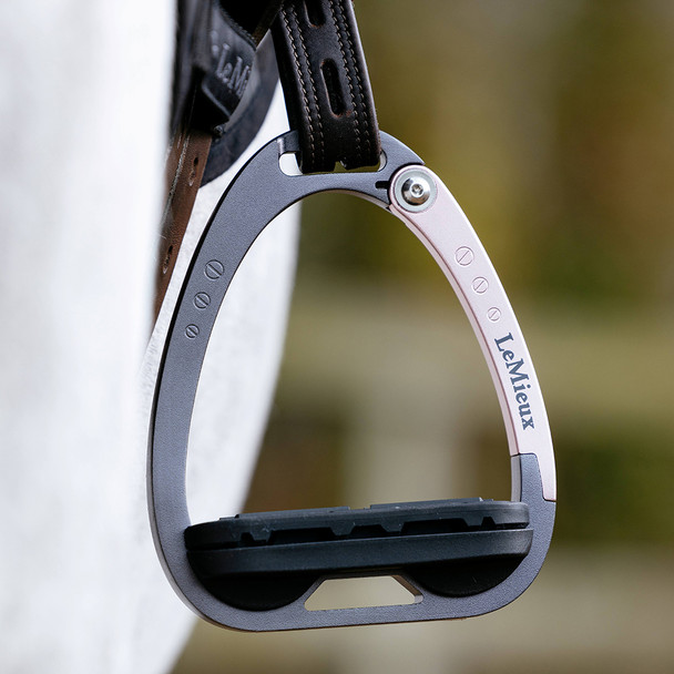 Pretty rose gold safety stirrups on a pony.