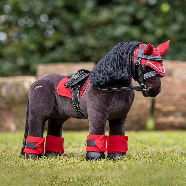 LeMieux Toy Pony Freya tacked up with red saddle pad, ear bonnet and polos.