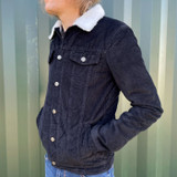 Man wears Madcap England Woburn Sherpa Trucker Jacket in Black