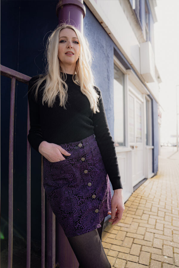 Woman wears Madcap England 60s Style Paisley Cord Mini Skirt and Black Turtleneck
