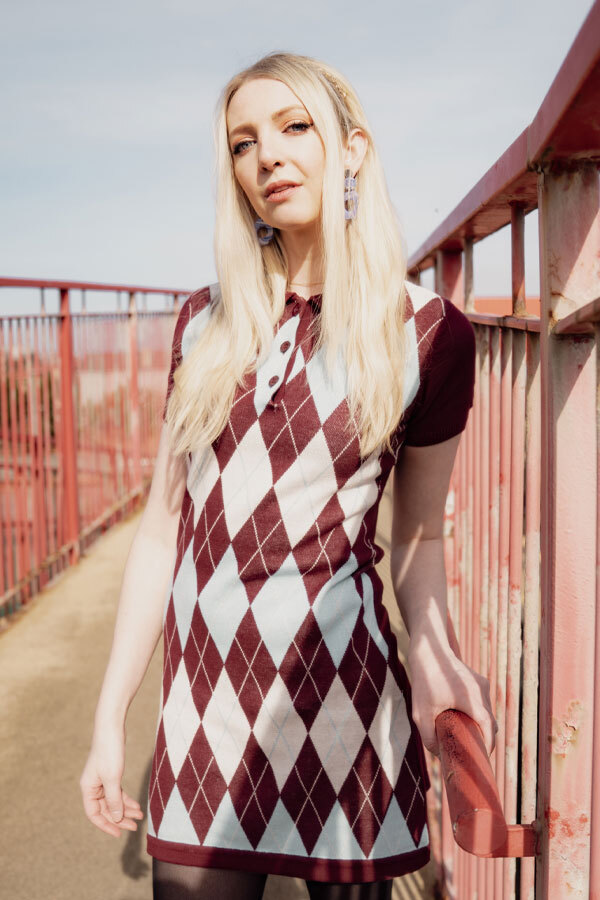 Woman wears Madcap England knitted argyle mod dress in zinfandel