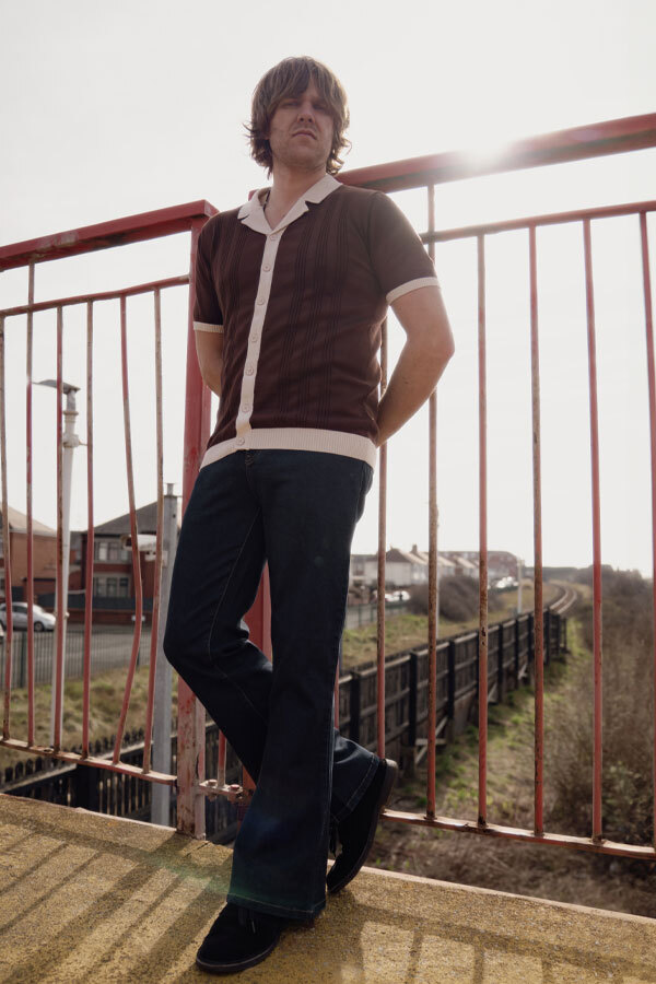 Man wears Madcap England Resort Collar Retro Knitted Shirt