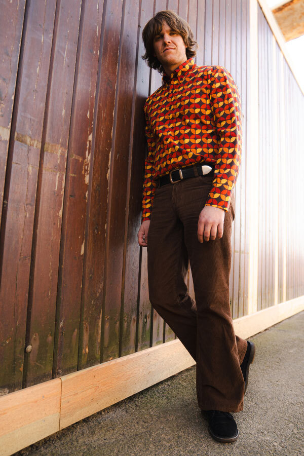 Man wears Madcap England Killer Flares in Cocoa and Retro Button Down 70s Shirt