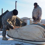 Ahkio sled being packed and tied down
