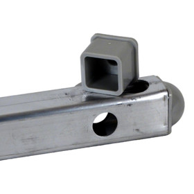 Military cot replacement part showing silver-gray rectangular metal tubing with drilled hole and gray plastic plug positioned on top, displaying inside of the 1.25-inch square fitting used in army folding cots