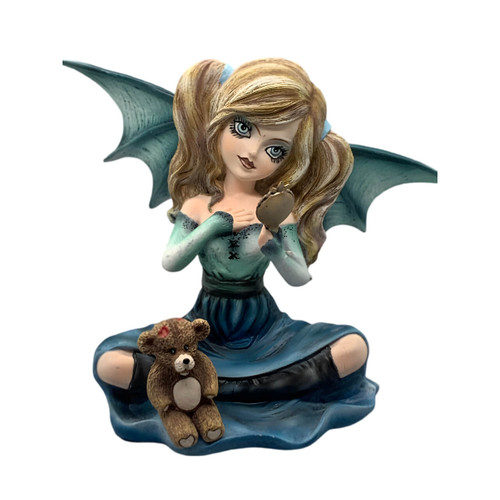 Gothic fairy figurine with bat wings, holding a mirror, sitting next to a small teddy bear. She has long blonde hair and wears a gradient blue dress.