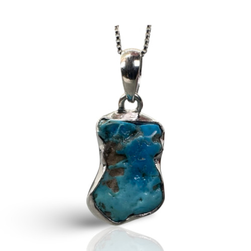 Rough Turquoise Necklace with natural blue turquoise stone in a handcrafted silver pendant on a chain.