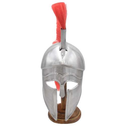 A shining silver Corinthian helmet with a vibrant red horsehair plume, resting on a wooden stand.
