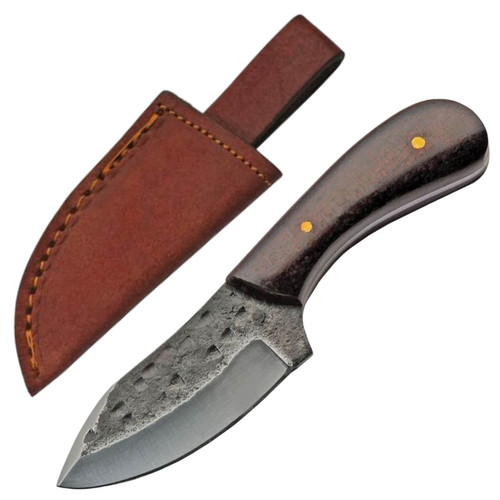 Rustic skinner knife with a dark, hammered blade, textured handle, and a brown stitched leather sheath with a belt loop. Rustic skinner knife with a dark, hammered blade, textured handle, and a brown stitched leather sheath with a belt loop.