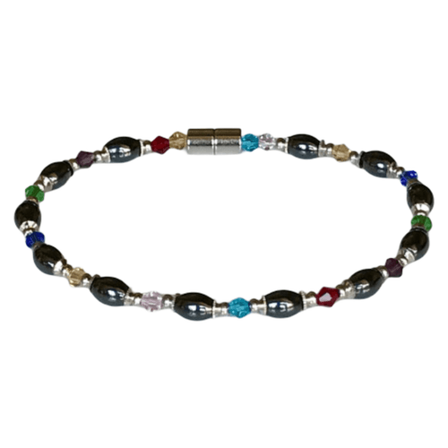 Multi-crystal magnetic anklet featuring black oval stones and colorful crystal beads in various shapes and colors, with a metallic magnetic clasp.