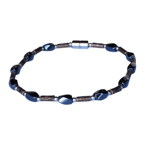 A rustic-chic magnetic anklet featuring twisted black hematite stones and long, antique-style copper tube beads with a polished magnetic clasp