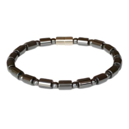 A minimalist black bead bracelet featuring polished, cylindrical hematite stones and tiny spacer beads, completed with a sleek gold magnetic clasp.