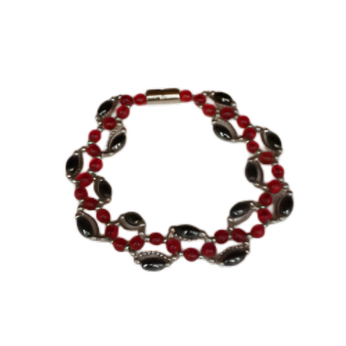 An eye-catching, multi-strand magnetic bracelet featuring alternating small red seed beads and larger, black obsidian nugget-style stone links, completed with a sleek silver magnetic clasp.