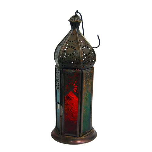 A tall, slender Moroccan lantern showcasing a weathered antique copper finish. The design features a sharply tapered dome with detailed geometric metal cutouts, a top hanging hook, and textured pressed glass panels in contrasting shades of red, green, and blue.