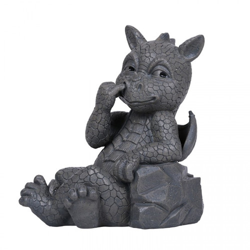Playful gray dragon sculpture sitting on a rock, picking its nose with a clawed finger and wearing a mischievous smile.