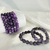Lepidolite gemstone beaded bracelets with natural purple and lavender round stones, displayed on a white silky backdrop.