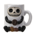 Whimsical white mug shaped like a skeleton with a skull face, black arms holding a coffee bean, and two additional coffee bean shapes at the base.