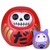 Two resin figurines, a red Daruma doll with a skull design and a small purple cat figurine, both styled as good luck charms.