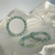 Three amazonite gemstone bracelets with spherical beads in varying shades of pale blue, green, and white