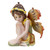 Small fairy statue with yellow flower crown, long brown hair, and orange-brown wings, sitting in a thoughtful pose, wearing a green and yellow dress.