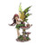A fairy statue sitting on a spotted mushroom, with flowing auburn hair, green attire, and large yellow and green wings. A small snail is beside her on the mushroom.