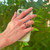 Hand model wearing Wired Heart Magnetic Copper Ring, highlighting its stylish and pure copper composition