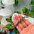Green gemstone chain magnetic bracelet displayed against a hand for size reference.