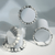White howlite beaded stretch bracelets, showing variations in bead size and natural gray-black matrix veining.