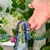 Firefly bead bracelets shown with hand for size comparison