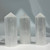 Three upright, milky white selenite points with subtle vertical lines