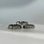 A stainless steel spinner ring with a celestial pattern of moons and stars cut out of the spinning outer band.