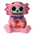 A small, charming collectible figurine featuring a skeleton character wearing a pink axolotl costume. The costume has textured gills and spots and is tied with a navy blue bow tie around the skeleton's neck. The skeleton's white face, black eye sockets, and stitched grin are visible inside the hood. The figure is sitting down and holding a small, orange, segmented worm.