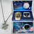 On the left, a silver-tone necklace features a bow-and-arrow pendant. The top right displays the kit's blue inner packaging, which contains an oyster preserved in a liquid-filled container and a heart-shaped display holding the necklace. The bottom right shows the outer box cover featuring a cosmic illustration of a centaur archer and the text "Sagittarius Love Pearl."