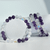 Three Amethyst and Aura gemstone stretch bracelets standing upright, showcasing natural purple amethyst beads paired with iridescent aura crystal beads.