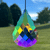 Faceted multicolored teardrop suncatcher hanging outdoors against a blurred blue sky, trees, and grassy field.