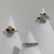Display of multicolor tourmaline vine rings on white jewelry stands, highlighting botanical vine designs and vibrant multicolored gemstones.