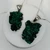 Two raw malachite crystal pendant necklaces featuring natural deep green formations and silver bails.